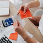 A sole trader organising receipts and financial records at a desk