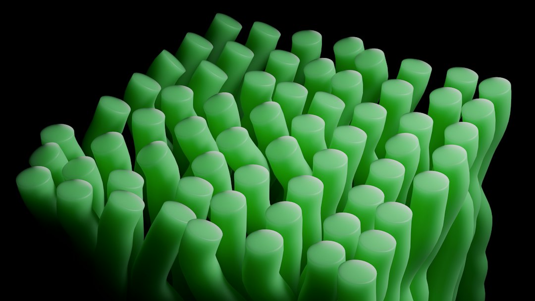Rows of glowing green cylindrical forms against a dark background, suggesting cultivated algae